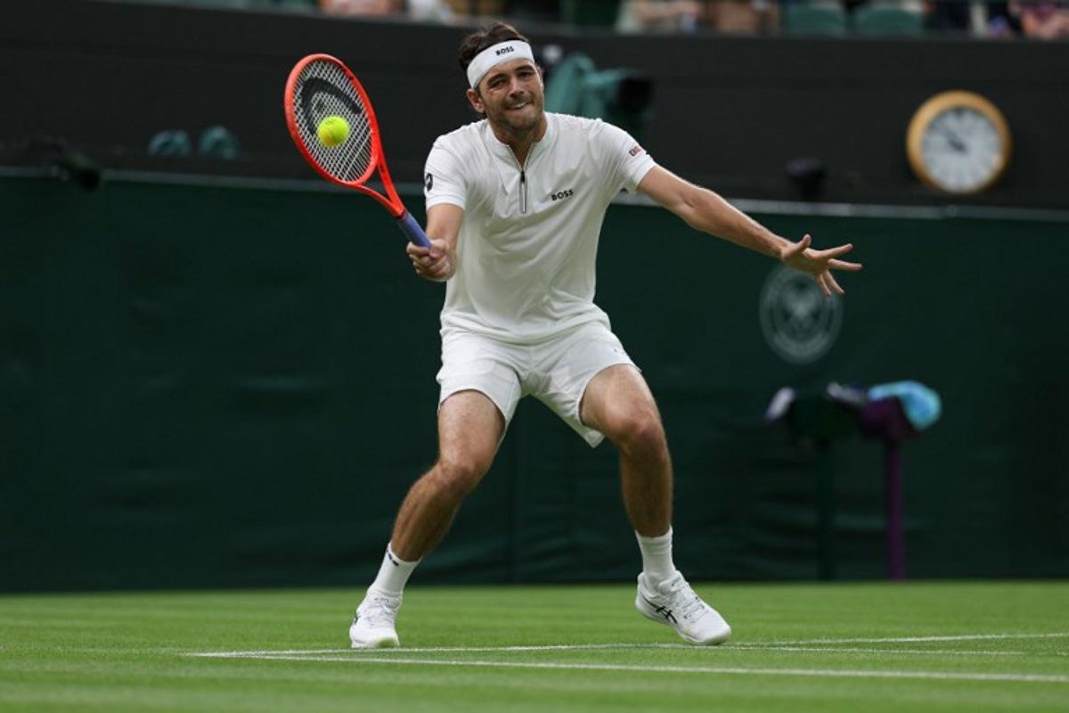 US Taylor Fritz plays a forehand return to France's Giovanni Mpetshi Perricard during their men's singles first round tennis match on the first day of the 2025 Wimbledon Championships at The All England Lawn Tennis and Croquet Club in Wimbledon, southwest London, on June 30, 2025.  Adrian Dennis / AFP