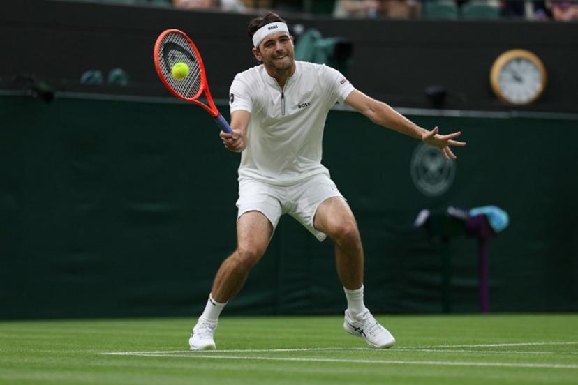 US Taylor Fritz plays a forehand return to France's Giovanni Mpetshi Perricard during their men's singles first round tennis match on the first day of the 2025 Wimbledon Championships at The All England Lawn Tennis and Croquet Club in Wimbledon, southwest London, on June 30, 2025.  Adrian Dennis / AFP