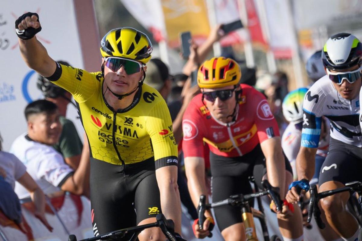 Visma-Lease a Bike team's Belgian rider Olav Kooij (L) celebrates while crossing the finish line to win the fourth stage of the Tour of Oman cycling race from Oman Across Ages Museum to Oman Convention Center, on February 11, 2025.   Loic VENANCE / AFP