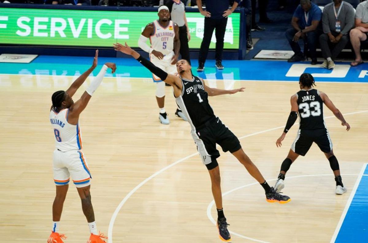 San Antonio Spurs French center #01 Victor Wembanyama reaches to block a shot by Oklahoma City Thunder's US forward #08 Jalen Williams during the NBA pre-season basketball game between San Antonio Spurs and Oklahoma City Thunder at Paycom Center arena in Oklahoma City, Oklahoma, on October 9, 2023.  TIMOTHY A. CLARY / AFP