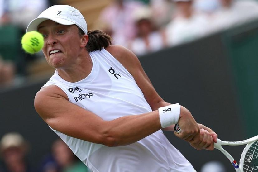 Poland's Iga Swiatek plays a backhand return to Russia's Polina Kudermetova during their women's singles first round tennis match on the second day of the 2025 Wimbledon Championships at The All England Lawn Tennis and Croquet Club in Wimbledon, southwest London, on July 1, 2025.  Adrian Dennis / AFP
