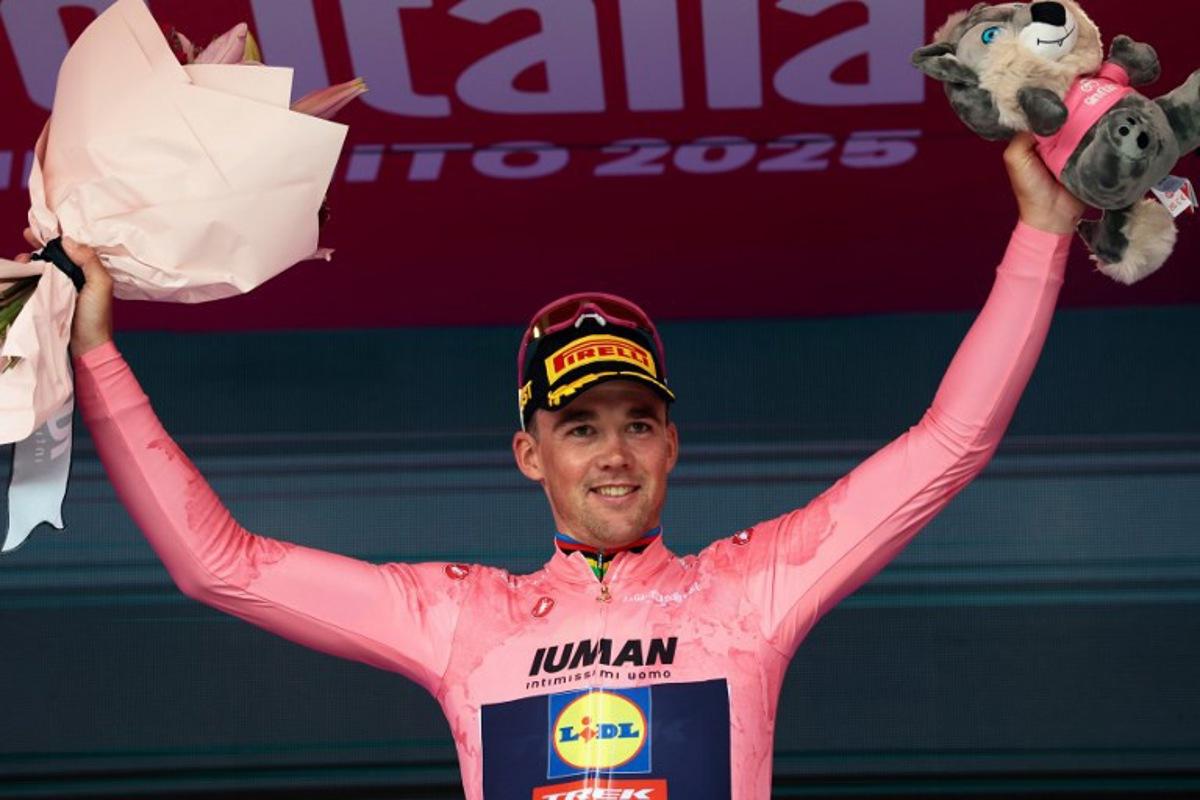 Stage winner Lidl-Trek's Danish rider Mads Pedersen wearing the overall leader's pink jersey (Maglia Rosa) celebrates on the podium after the 3rd stage of the 108th Giro d'Italia cycling race, 160km from Vlore to Vlore in Albania, on May 11, 2025.  Luca Bettini / AFP