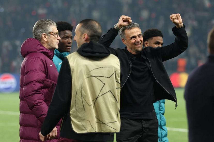 Paris Saint-Germain's Spanish coach Luis Enrique (R) celebrates his team's victory at the end of the UEFA Champions League semi-final second leg football match between Paris Saint-Germain (PSG) and Arsenal at the Parc des Princes stadium in Paris, on May 7, 2025.  FRANCK FIFE / AFP