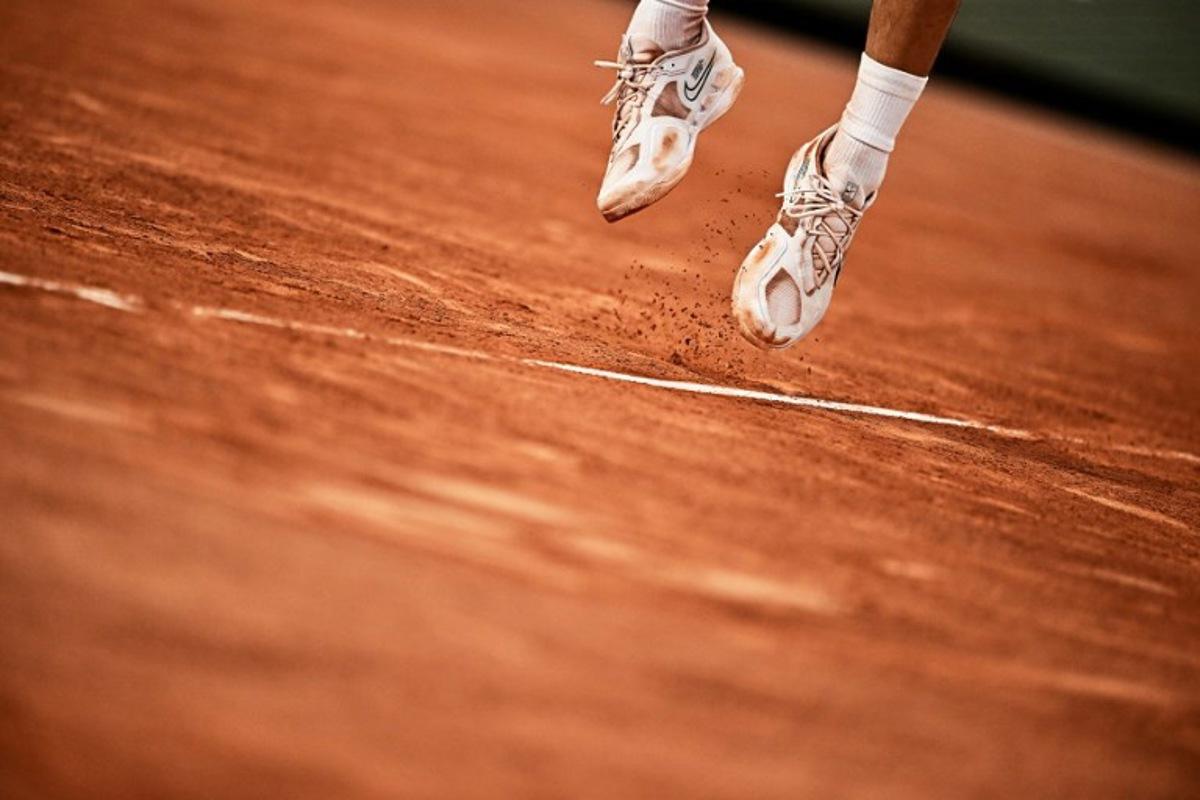 Clay falls from the sneakers of Spain's Carlos Alcaraz Garfia as he plays against Greece's Stefanos Tsitsipas during their men's singles quarter final match on day ten of the Roland-Garros Open tennis tournament at the Court Philippe-Chatrier in Paris on June 6, 2023.  JULIEN DE ROSA / AFP