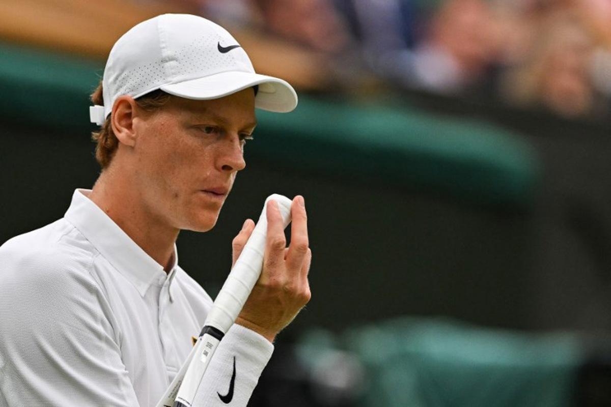 Italy's Jannik Sinner blows on his hand as he plays against Spain's Pedro Martinez during their men's singles third round tennis match on the sixth day of the 2025 Wimbledon Championships at The All England Lawn Tennis and Croquet Club in Wimbledon, southwest London, on July 5, 2025.  Glyn KIRK / AFP