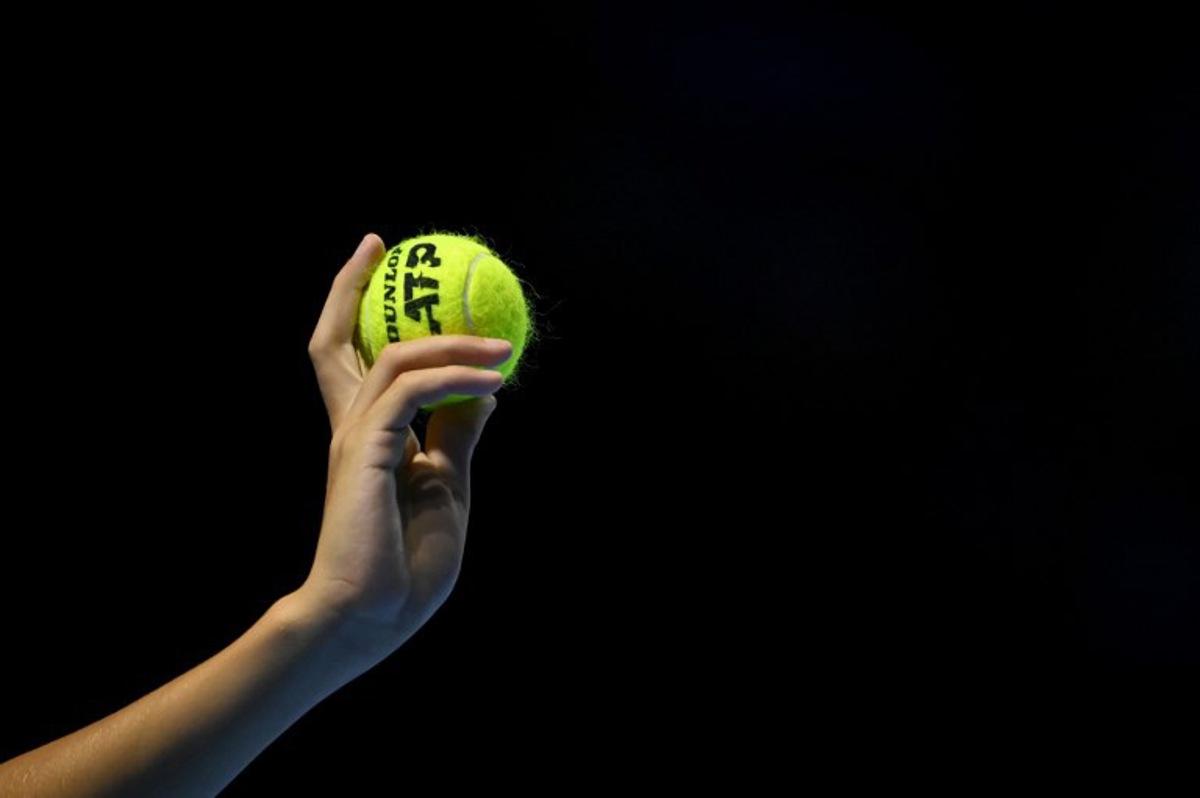 A ballboy hold up a tennis ball during a men's quarter final match at the Swiss Indoors ATP 500 tennis tournament in Basel on October 25, 2024.   Fabrice COFFRINI / AFP