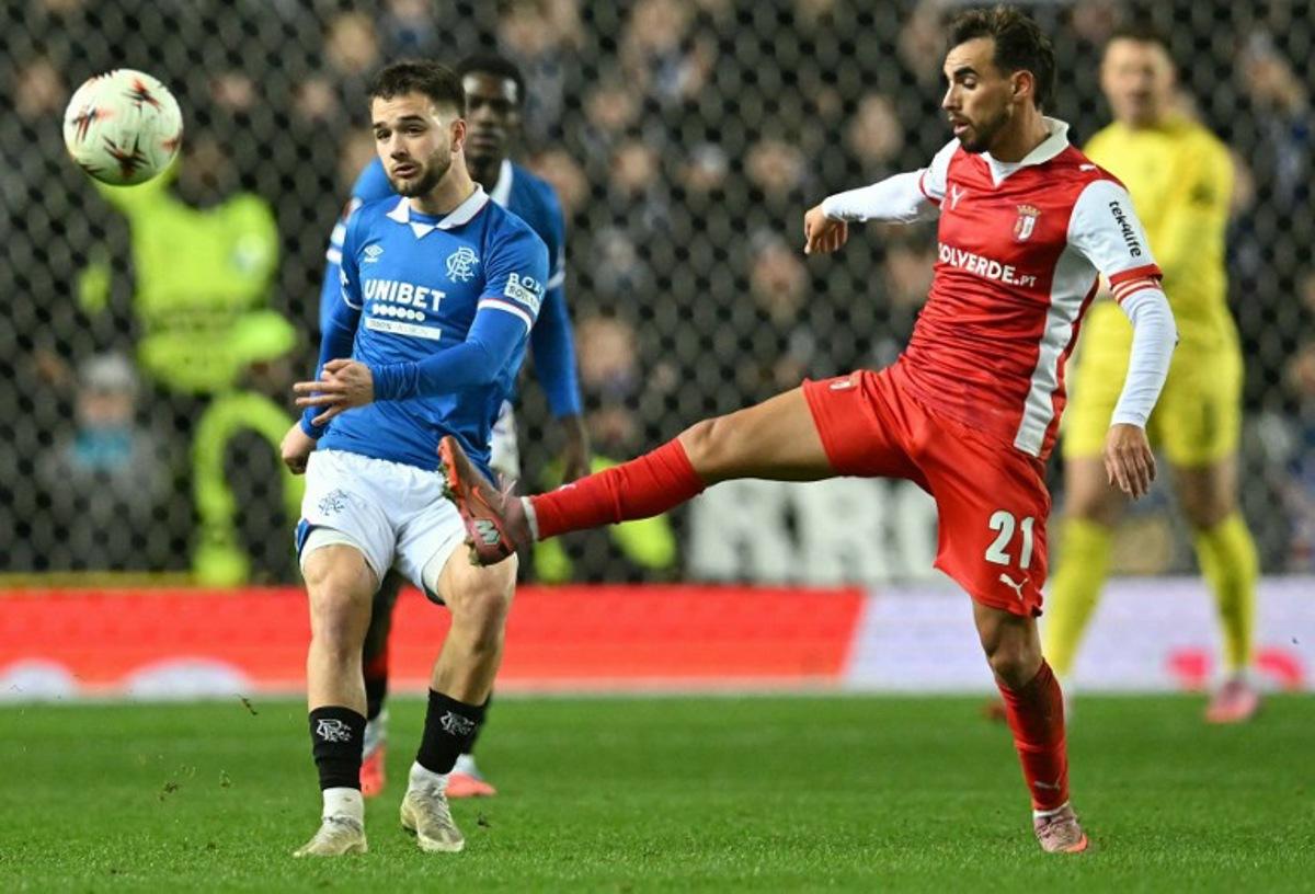 Sporting Braga's Portuguese midfielder #21 Ricardo Horta (R) vies with Rangers' Belgian midfielder #43 Nicolas Raskin during the UEFA Europa League league-stage football match between Rangers and CS Braga at the Ibrox Stadium in Glasgow on November 27, 2025.  ANDY BUCHANAN / AFP