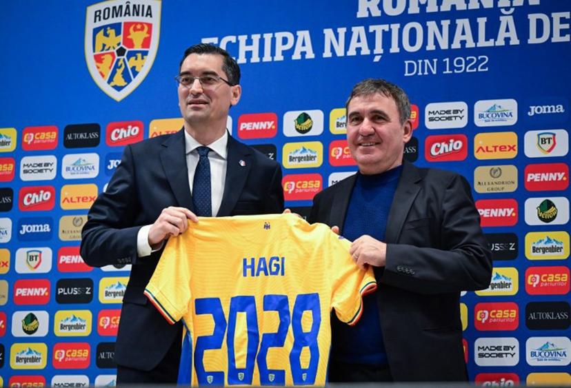 Romanian Football Federation president Razvan Burleanu (L) and the newly appointed head coach of Romania's national football team Gheorghe Hagi pose with a jersey during a press conference in Bucharest on April 20, 2026. Hagi signed a four-year contract to return to the helm of the national team. The 61-year-old legend, nicknamed "The King" and "Maradona of the Carpathians," succeeded the late Mircea Lucescu with ambitious goals to win the Nations League and qualify for the European Championships. Daniel MIHAILESCU / AFP