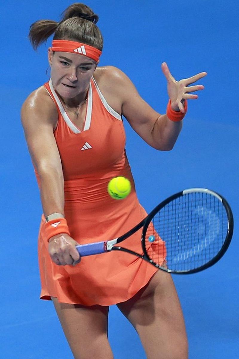 Czech Republic's Karolina Muchova hits a return to Canada's Victoria Mboko during their women's singles final match at the Qatar Open tennis tournament in Doha on February 14, 2026.  Karim JAAFAR / AFP