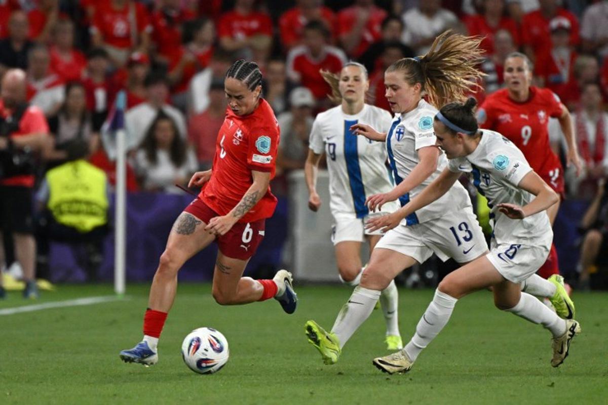 Switzerland's forward #06 Geraldine Reuteler, runs with the ball during the UEFA Women's Euro 2025 Group A football match between Finland and Switzerland at the Stade de Geneve in Geneva, on July 10, 2025.  Miguel MEDINA / AFP