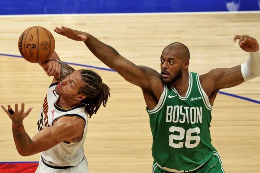 Denver Nuggets' forward #32 Aaron Gordon fights for the ball with Boston Celtics' forward #26 Xavier Tillman Sr during the NBA Preseason game between the Denver Nuggets and the Boston Celtics at the Etihad Arena in Abu Dhabi on October 4, 2024.  Fadel Senna / AFP