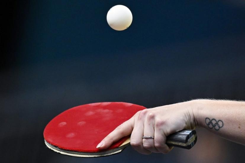 A tatoo depicting the Olympic rings is pictures on the wrist of Australia's Melissa Tapper as she plays against South Korea's Shin Yubin during their women's table tennis singles round of 64 at the Paris 2024 Olympic Games at the South Paris Arena in Paris on July 29, 2024.  WANG Zhao / AFP