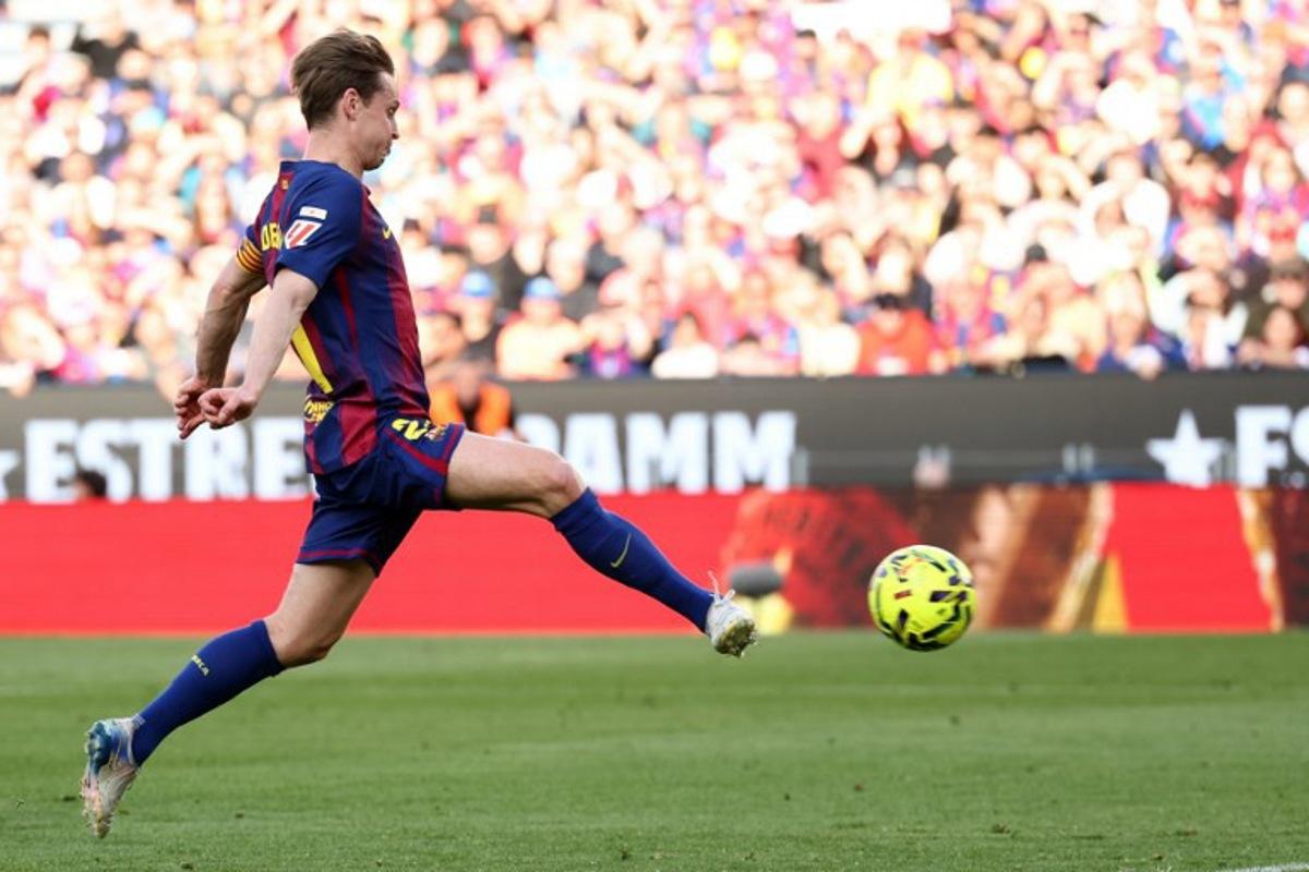 Barcelona's Dutch midfielder #21 Frenkie De Jong scores his team's second goal during the Spanish league football match between FC Barcelona and Levante UD at Camp Nou Stadium in Barcelona on February 22, 2026.  Josep LAGO / AFP