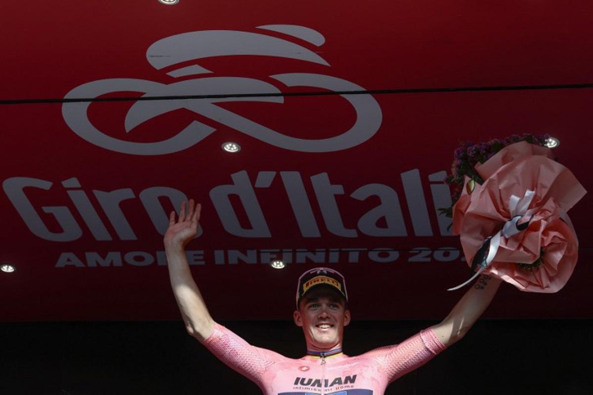 Lidl-Trek's Danish rider Mads Pedersen, wearing the overall leader's pink jersey (Maglia Rosa), celebrates on the podium after the 4th stage of the 108th Giro d'Italia cycling race 189kms from Alberobello to Lecce on May 13, 2025.  Luca Bettini / AFP