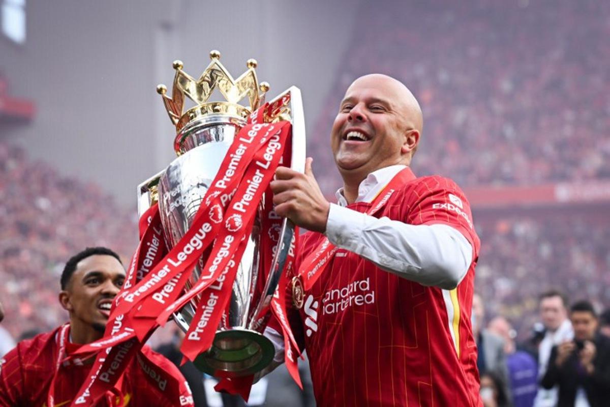 Liverpool's Dutch manager Arne Slot celebrates with the Premier League trophy at the end of the English Premier League football match between Liverpool and Crystal Palace at Anfield in Liverpool, north west England on May 25, 2025. Liverpool equalises 1 - 1 against Crystal Palace. Paul ELLIS / AFP