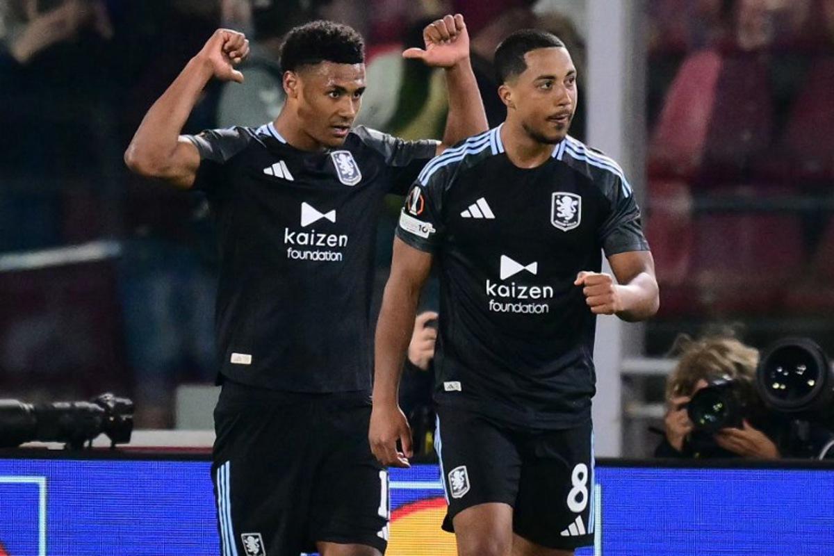 Aston Villa's English striker #11 Ollie Watkins celebrates scoring his team's third goal with Aston Villa's Belgian midfielder  #08 Youri Tielemans during the UEFA Europa League quarter final first leg football match between Bologna and Aston Villa at the Renato Dall'Ara stadium in Bologna on April 9, 2026.  Stefano RELLANDINI / AFP
