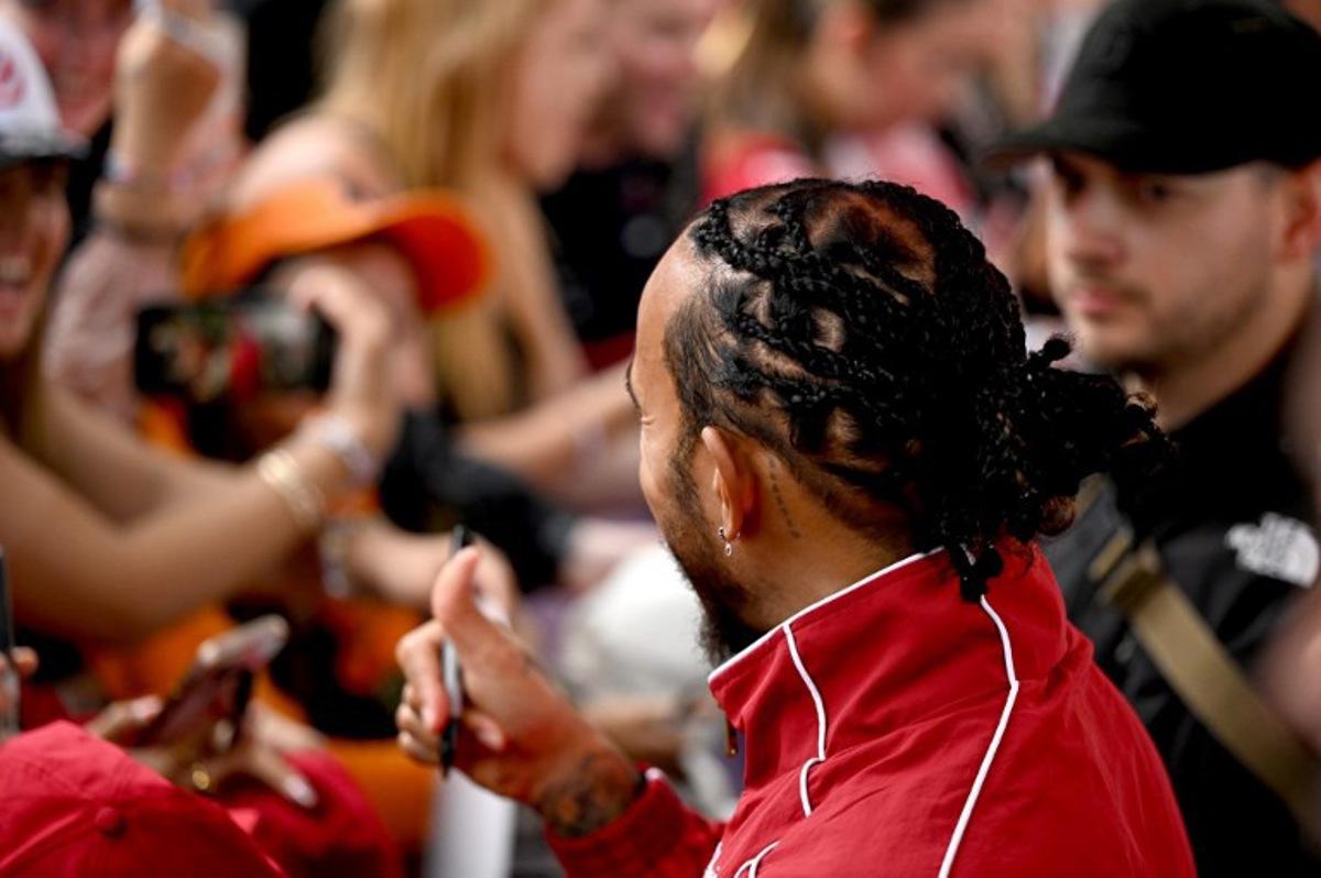 Ferrari's British driver Lewis Hamilton meets with fans as he arrives ahead of the Formula One Australian Grand Prix at the Albert Park Circuit in Melbourne on March 16, 2025.  Saeed KHAN / AFP