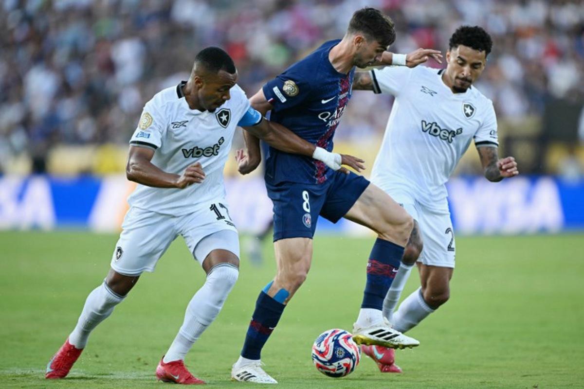 Paris Saint-Germain's Spanish midfielder #08 Fabian Ruiz, Botafogo's Brazilian midfielder #17 Marlon Freitas (L) and Brazilian midfielder #26 Gregore fight for the ball during the FIFA Club World Cup 2025 Group B football match between France's Paris Saint-Germain and Brazil's Botafogo at the Rose Bowl stadium in Los Angeles on June 19, 2025.  YURI CORTEZ / AFP