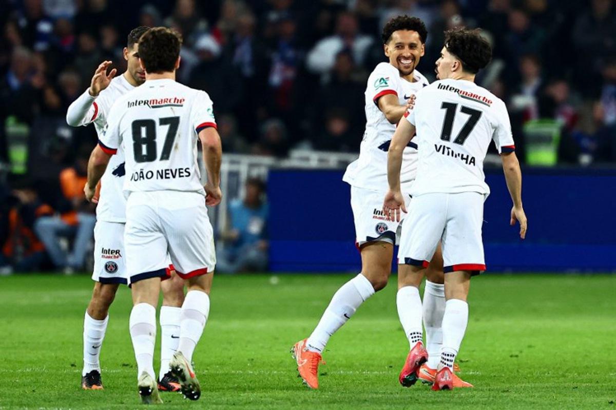 Paris Saint-Germain's Brazilian defender #05 Marquinhos (2nd R) celebrates with teammates after scoring his team's second goal during the French Cup (Coupe de France) semi-final football match between USL Dunkirk and Paris Saint-Germain (PSG) at the Pierre-Mauroy stadium in Villeneuve-d'Ascq, northern France, on April 1, 2025.  Sameer Al-Doumy / AFP