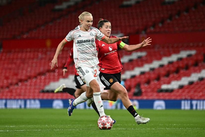 Bayern Munich's Danish forward #21 Pernille Harder (L) breaks past Manchester United's English defender #04 Maya Le Tissier (R) to score Bayern Munich's second goal during the UEFA Women's Champions League, Quarter Final first-leg football match between Manchester United and Bayern Munich at Old Trafford in Manchester, north west England, on March 25, 2025.  Paul ELLIS / AFP