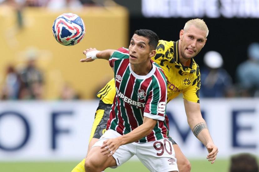 Fluminense's Colombian forward #90 Kevin Serna and Borussia Dortmund's German defender #25 Niklas Suele vie for the ball during the FIFA Club World Cup 2025 Group F football match between Brazil's Fluminense and Germany's Borussia Dortmund at the MetLife stadium in East Rutherford, New Jersey on June 17, 2025.  CHARLY TRIBALLEAU / AFP