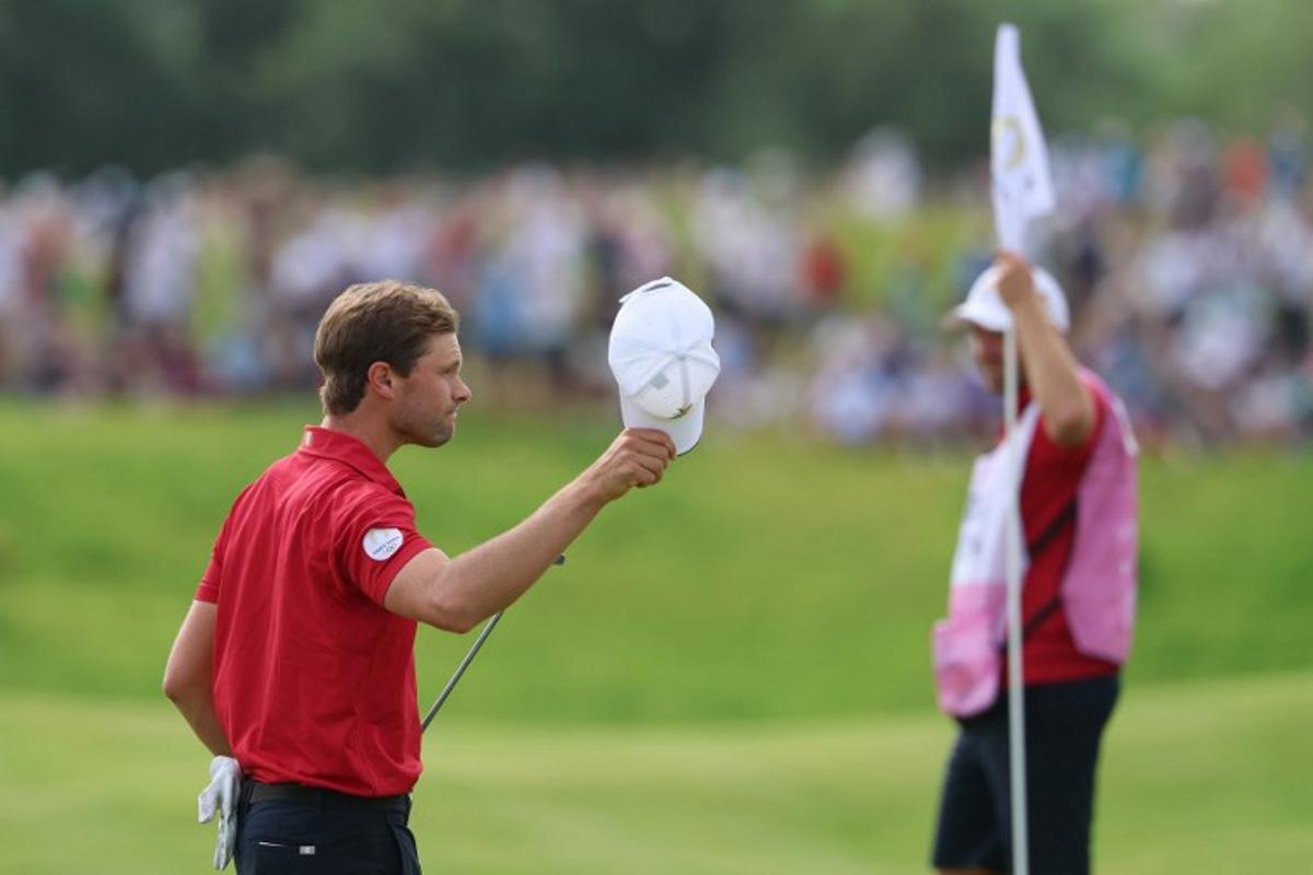Belgium's Thomas Detry gestures after completing the course in round 4 of the men's golf individual stroke play of the Paris 2024 Olympic Games at Le Golf National in Guyancourt, south-west of Paris on August 4, 2024.   Emmanuel DUNAND / AFP