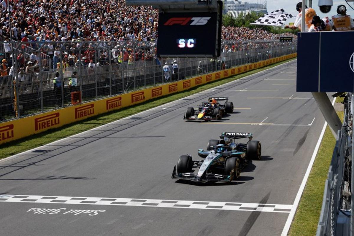 Mercedes' British driver George Russell crosses the finish line as he wins the race, followed by Red Bull Racing's Dutch driver Max Verstappen in second place, during the 2025 Formula 1 Grand Prix du Canada at Circuit Gilles-Villeneuve in Montreal, Canada, on June 15, 2025.   SHAWN THEW / POOL / AFP