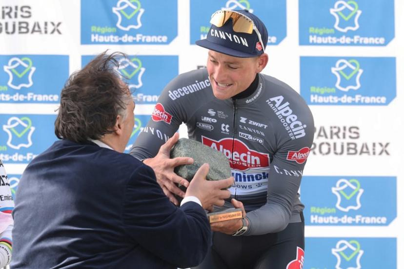 First placed Alpecin-Deceuninck's Dutch rider Mathieu van der Poel (R) celebrates with his award on the podium of the 122nd edition of the Paris-Roubaix one-day classic cycling race, 259,2 km between Compiegne and Roubaix, northern France on April 13, 2025. Mathieu van der Poel won cycling's Paris-Roubaix for a third straight time on April 13, 2025 edging Tour de France champion Pogacar in the race nick-named 'The Hell of the North'. Francois LO PRESTI / AFP