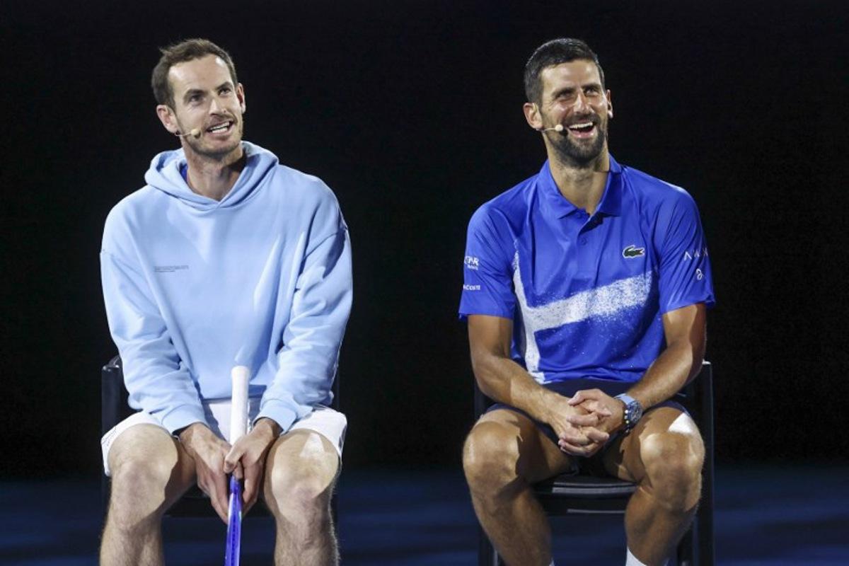 Britain's Andy Murray (L) reacts with Serbia's Novak Djokovic during a charity event titled 'Night with Novak' on Rod Laver Arena in Melbourne on January 9, 2025 ahead of the Australian Open tennis championship starting on January 12.   DAVID GRAY / AFP