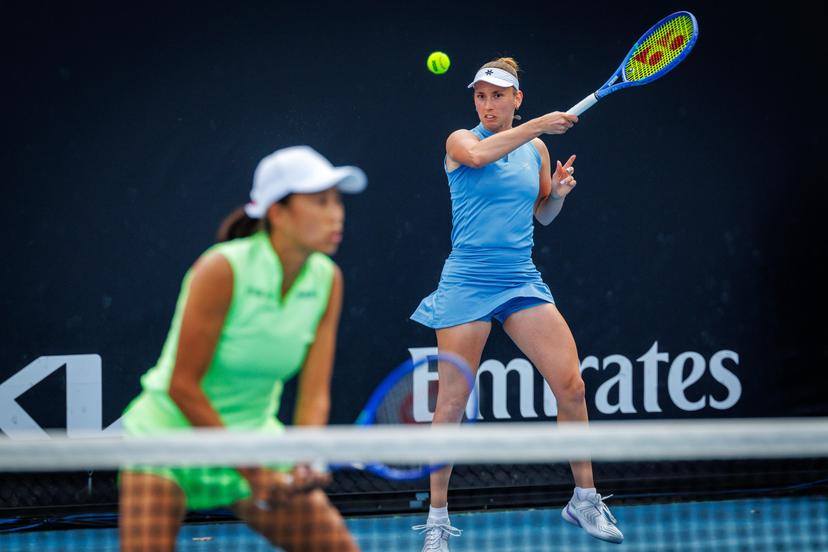 Belgian Elise Mertens (blue) and Chinese Zhang Shuai (green) pictured in action during a first round match of Belgium-China's Mertens-Shuai pair against Romania-Russia's pair Cirstea-Kalinskya in the women doubles at the Australian Open, Melbourne Park, Melbourne on Wednesday 21 January 2026. Mertens - Shuai won the game. BELGA PHOTO PATRICK HAMILTON  --- BENELUX ONLY   ---