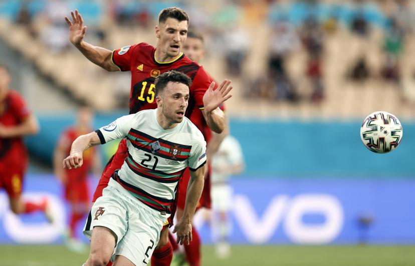 Portugal's Diogo Jota and Belgium's Thomas Meunier fight for the ball during the round of 16 game of the Euro 2020 European Championship between the Belgian national soccer team Red Devils and Portugal, in Sevilla, Spain, Sunday 27 June 2021. BELGA PHOTO BRUNO FAHY