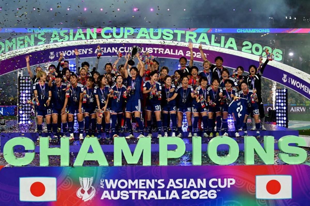 Japan's team celebrate with the trophy after winning the final of the AFC Women's Asian Cup Australia 2026 football tournament between Australia and Japan at Stadium Australia in Sydney on March 21, 2026.  Saeed Khan / AFP