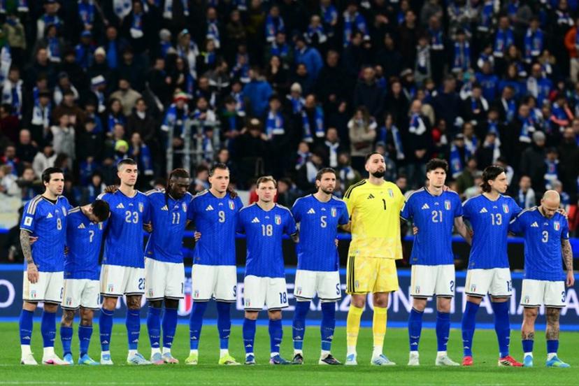 Italy's players stand on the pitch during the national anthems before the play-off FIFA World Cup 2026 European qualification semi-final football match between Italy and North Ireland at the Gewiss stadium in Bergamo, on March 26, 2026.   Stefano RELLANDINI / AFP