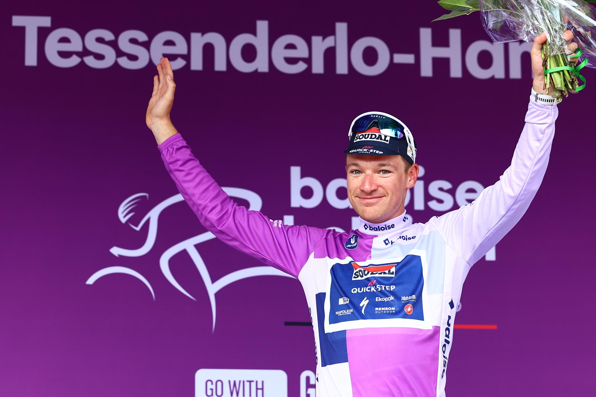 British Ethan Hayter of Soudal Quick-Step celebrates on the podium in the leader's jersey after winning the third stage of the Baloise Belgium Tour cycling race, a 9,7km individual time trial from Tessenderlo to Ham, Friday 20 June 2025. The Baloise Belgium Tour takes place from 18 to 22 June. BELGA PHOTO DAVID PINTENS