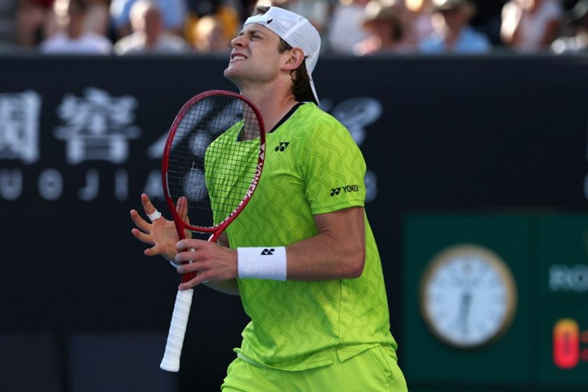 Belgium's Zizou Bergs reacts after a point against Poland's Hubert Hurkacz during their men's singles match on day three of the Australian Open tennis tournament in Melbourne on January 20, 2026.  IZHAR KHAN / AFP