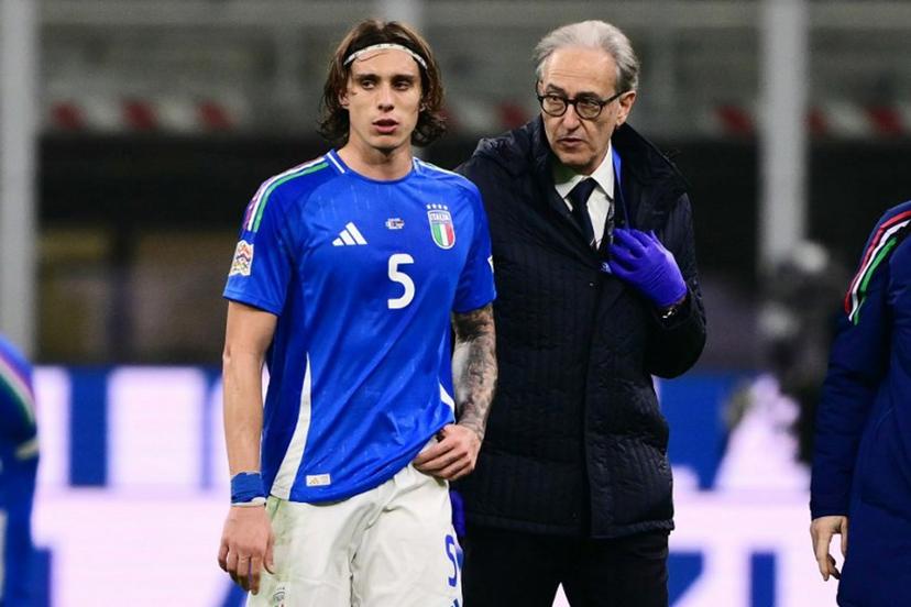 Italy's defender #05 Riccardo Calafiori leaves the pitch after an injury during the Nations League quarter final first leg football match between Italy and Germany at the San Siro Stadium in Milan, on March 20, 2025.  Marco BERTORELLO / AFP
