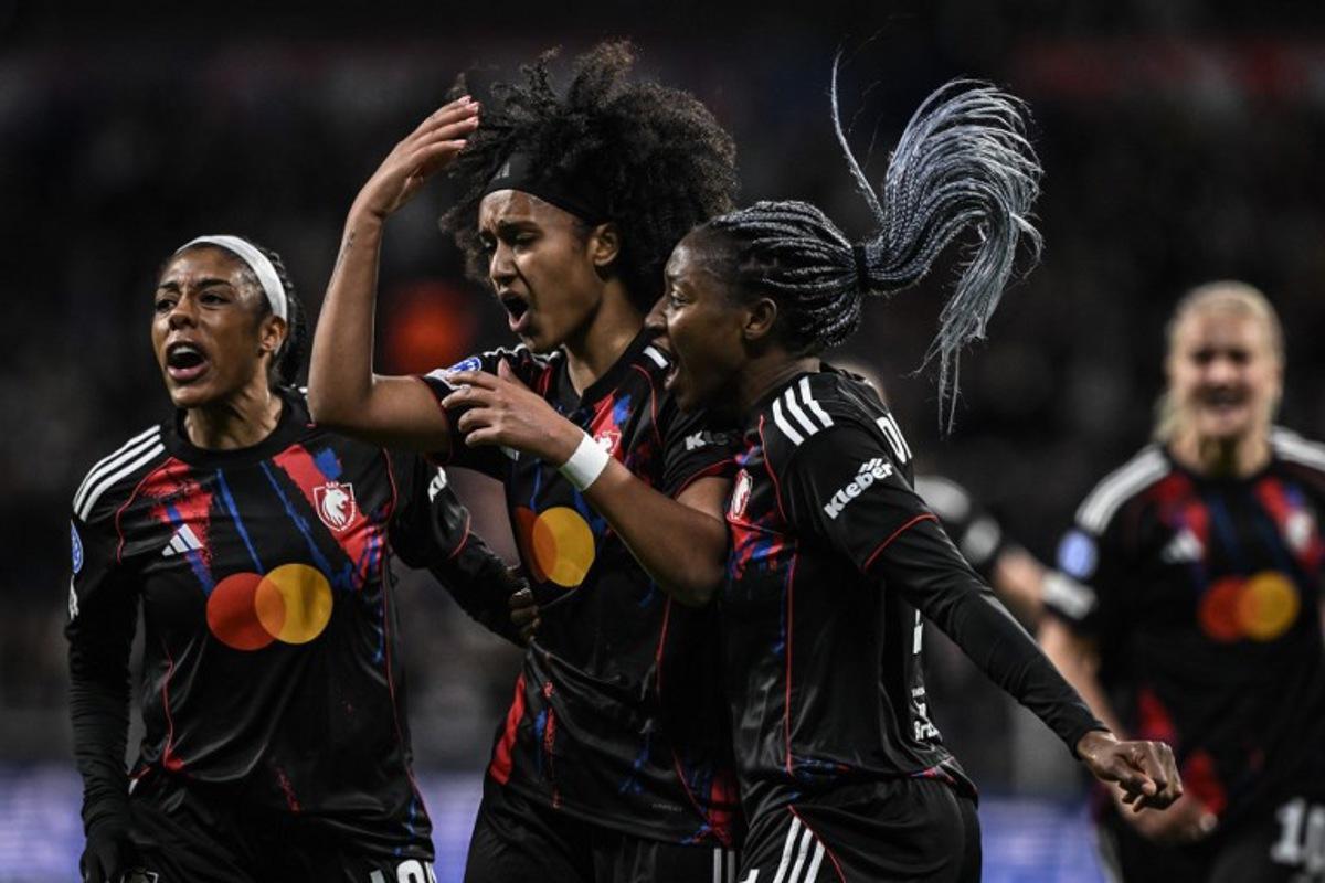 Lyon's US midfielder #20 Lily Yohannes (C) celebrates with teammates after scoring her team's first goal during the UEFA Women's Champions League quarter final second leg football match between OL Lyonnes (Lyon) and VfL Wolfsburg at the Groupama stadium in Decines-Charpieu, central-eastern France, on April 2, 2026.  JEFF PACHOUD / AFP