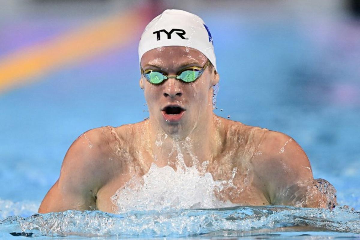 France's swimmer Leon Marchand competes in a heat of the men's 200m individual medley swimming event during the 2025 World Aquatics Championships in Singapore on July 30, 2025.  MANAN VATSYAYANA / AFP