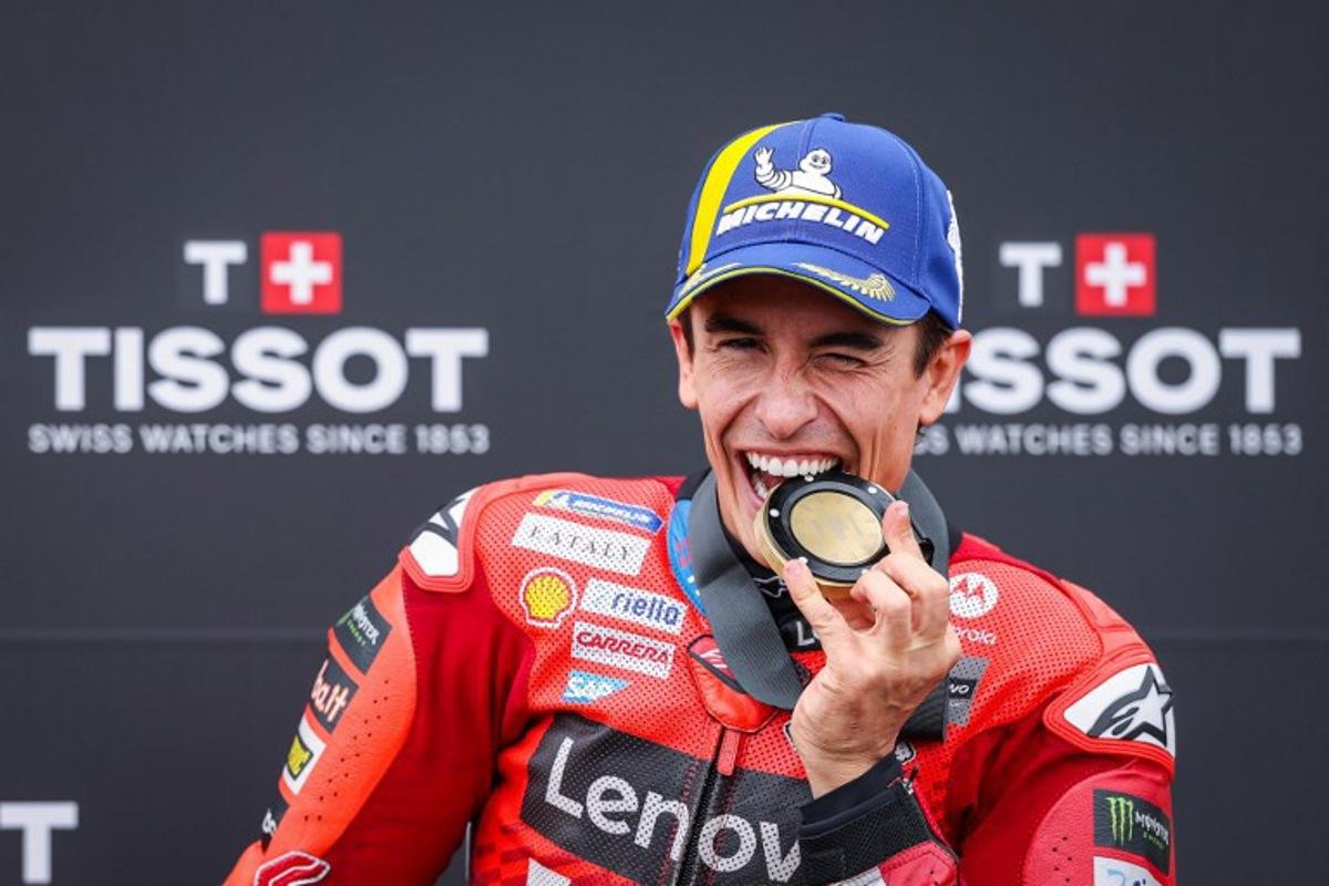 Ducati Lenovo Team's Spanish MotoGP rider Marc Marquez celebrates after winning the sprint race of the MotoGP German motorcycle Grand Prix at the Sachsenring racing circuit, in Hohenstein-Ernstthal near Chemnitz, eastern Germany on July 12, 2025.  Ronny Hartmann / AFP