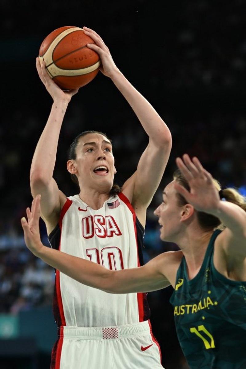 USA's #10 Breanna Stewart takes a shot over Australia's #11 Alanna Smith in the women's semifinal basketball match between USA and Australia during the Paris 2024 Olympic Games at the Bercy Arena in Paris on August 9, 2024.  Paul ELLIS / AFP