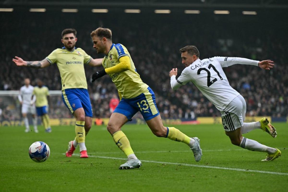 Fulham's Belgian defender #21 Timothy Castagne (R) chases Southampton's Brazilian midfielder #13 Leo Scienza (C) during the English FA Cup fifth round football match between Fulham and Southampton at Craven Cottage in London on March 8, 2026.  Glyn KIRK / AFP