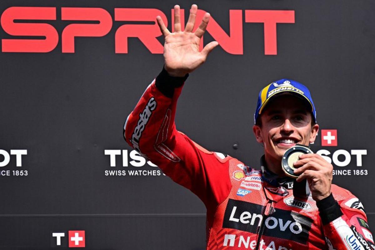 Ducati Lenovoi Team's Spanish MotoGP rider Marc Marquez celebrates after winning the sprint, on the eve of the Italian Moto GP Grand Prix at Mugello circuit, in Mugello, near Florence, on June 21, 2025.   Tiziana FABI / AFP