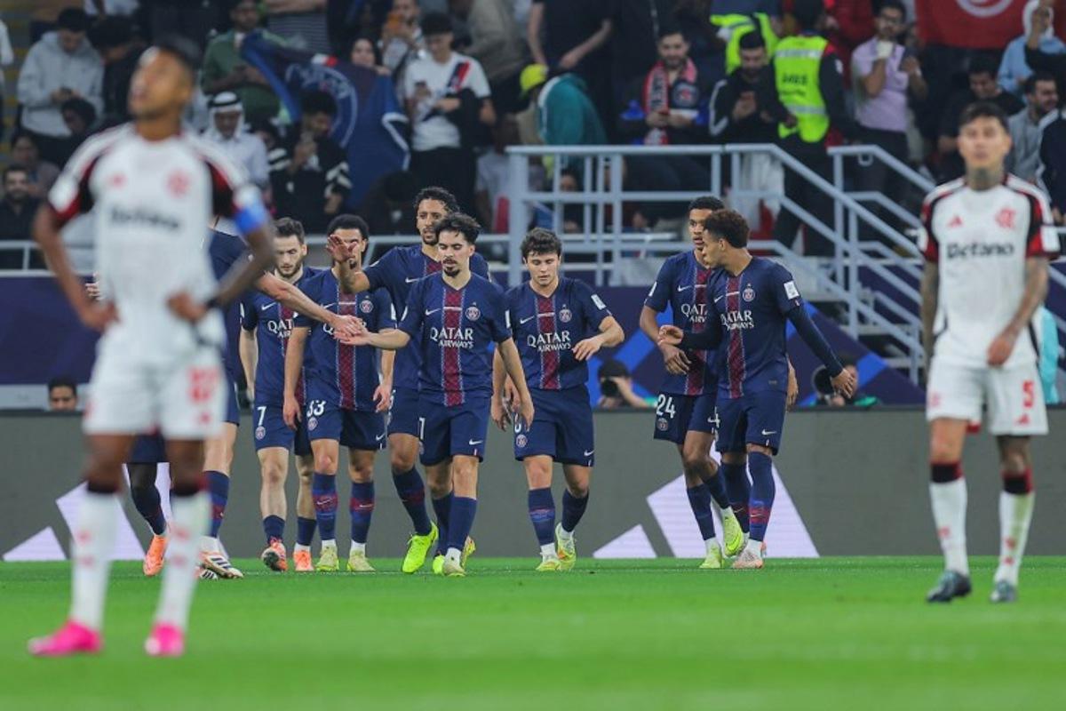 PSG players celebrate after Paris Saint-Germain's Georgian forward #07 Khvicha Kvaratskhelia scored the team's first goal during the 2025 FIFA Intercontinental Cup final football match between Paris Saint-Germain (PSG) and CR Flamengo at the Ahmad bin Ali Stadium in Al-Rayyan on the outskirts of Doha on December 17, 2025.  Karim JAAFAR / AFP