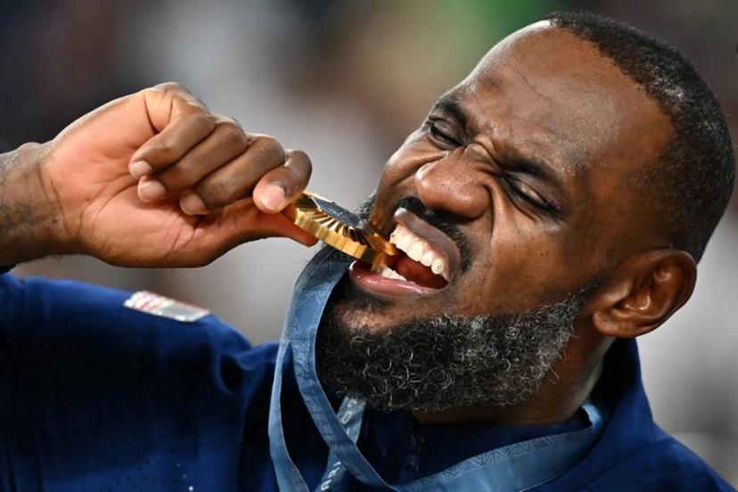 Gold medallist USA's #06 LeBron James poses on the podium after the men's Gold Medal basketball match between France and USA during the Paris 2024 Olympic Games at the Bercy  Arena in Paris on August 10, 2024.  Aris MESSINIS / AFP