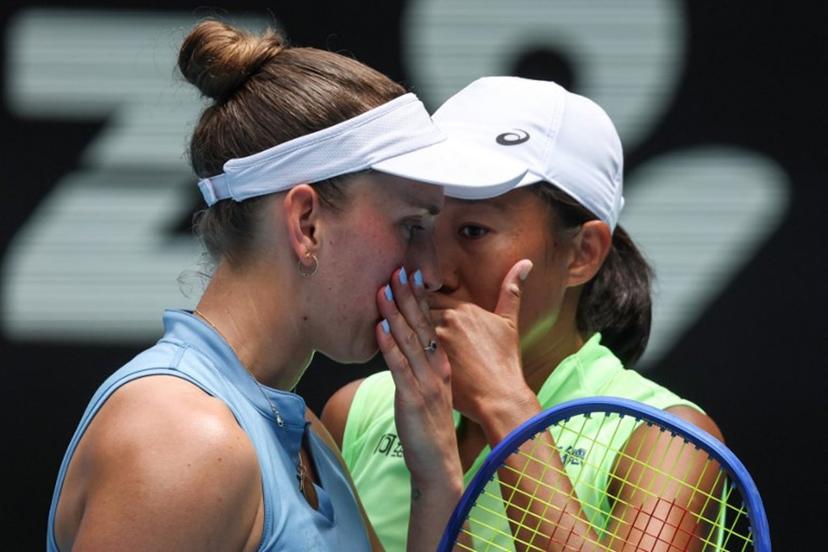 Belgium's Elise Mertens talks to partner China's Zhang Shuai (R) during their women's doubles final match against Kazakhstan's Anna Danilina and Serbia's Aleksandra Krunic on day fourteen of the Australian Open tennis tournament in Melbourne on January 31, 2026.  DAVID GRAY / AFP