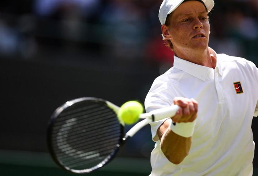 Italy's Jannik Sinner plays a forehand return to Italy's Luca Nardi during their men's singles first round tennis match on the second day of the 2025 Wimbledon Championships at The All England Lawn Tennis and Croquet Club in Wimbledon, southwest London, on July 1, 2025.  HENRY NICHOLLS / AFP