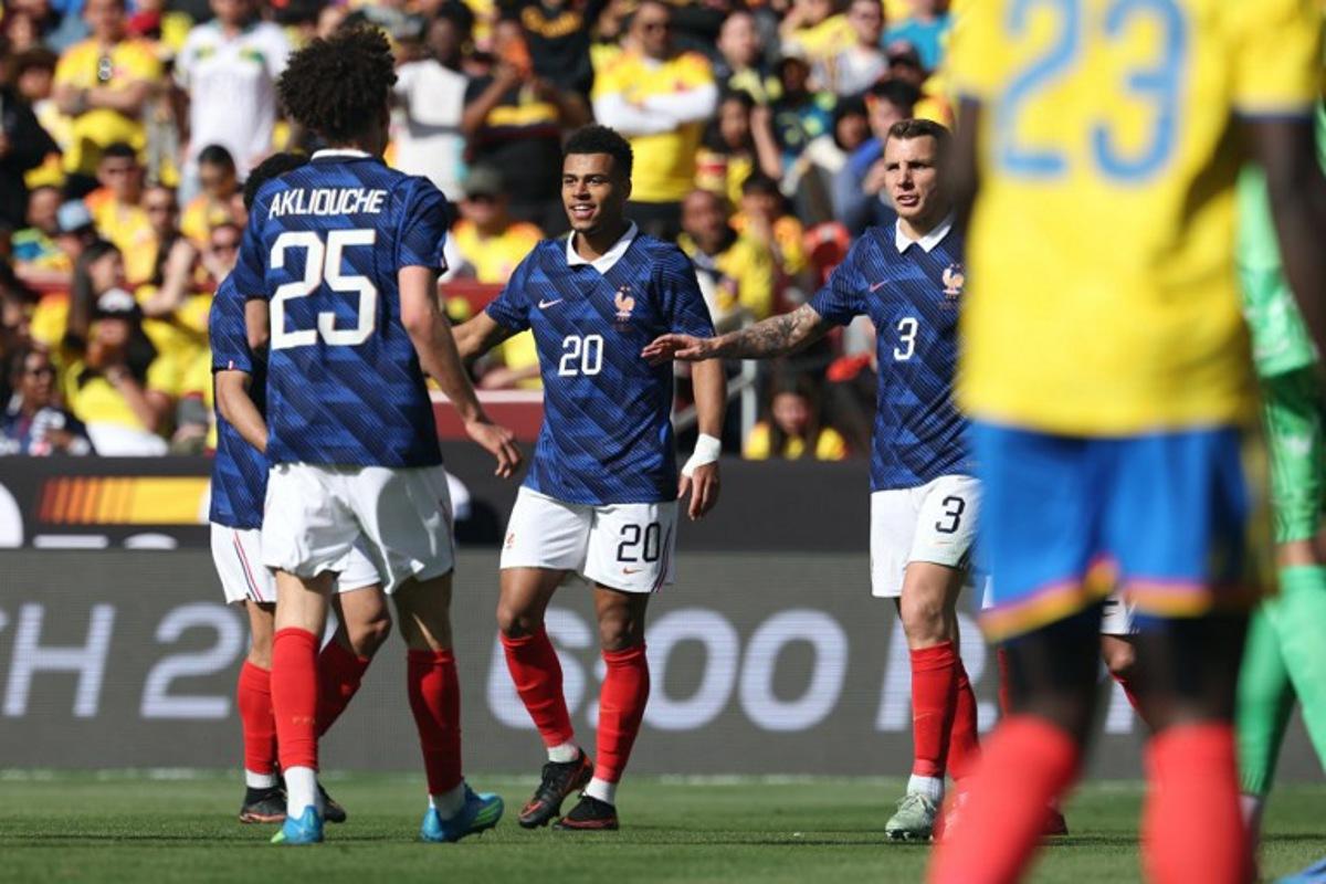 France's forward #20 Desire Doue is congratulated by teammates after scoring his second goal during a friendly football match between Colombia and France at Northwest Stadium in Landover, Maryland, on March 29, 2026.  FRANCK FIFE / AFP