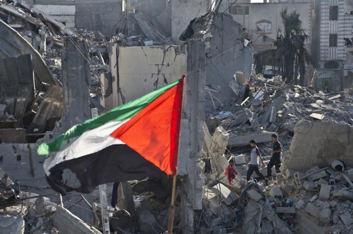 Two Palestinian boys walk amid the rubble of destroyed homes in Shejaiya on August 27, 2014. Shejaiya is one of the hardest hit neighborhoods in fighting between Hamas militants and Israel during 50 days of fighting. Israel and Palestinians both boasted of victory in the Gaza war but analysts say Hamas received only promises while the conflict aggravated divisions in the Israeli leadership.  AFP PHOTO / ROBERTO SCHMIDT  Roberto SCHMIDT / AFP