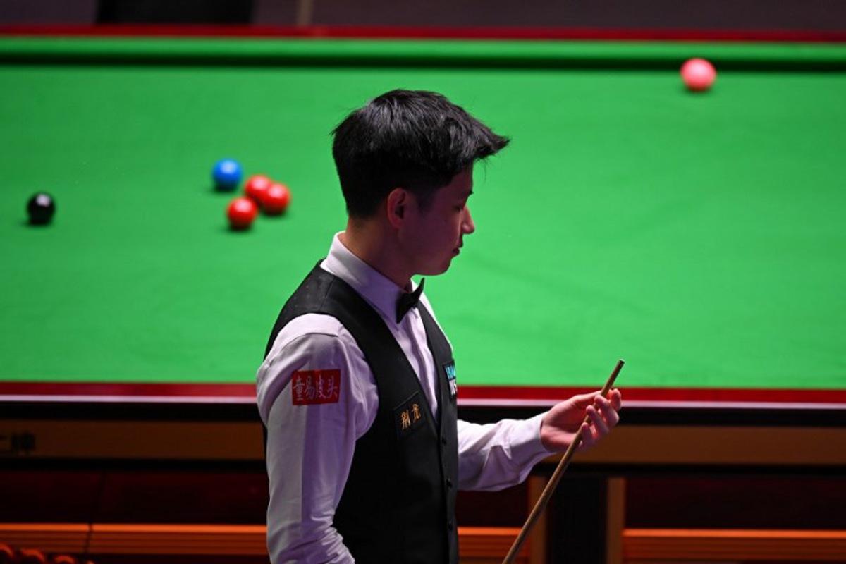 China's Zhao Xintong at the table on day two of his World Championship Snooker final against Wales' Mark Williams during the afternoon session at The Crucible in Sheffield, northern England on May 5, 2025.   Oli SCARFF / AFP