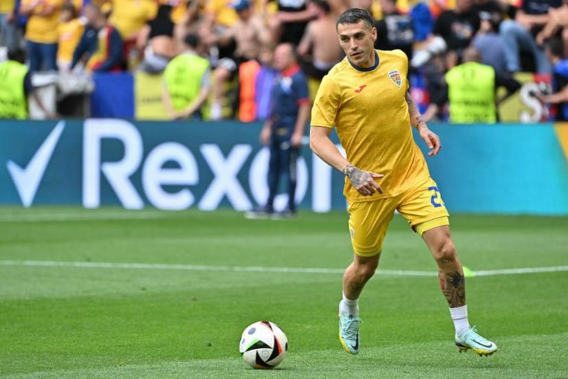 Romania's midfielder #21 Nicolae Stanciu warms up ahead of the UEFA Euro 2024 round of 16 football match between Romania and the Netherlands at the Munich Football Arena in Munich on July 2, 2024.  MIGUEL MEDINA / AFP